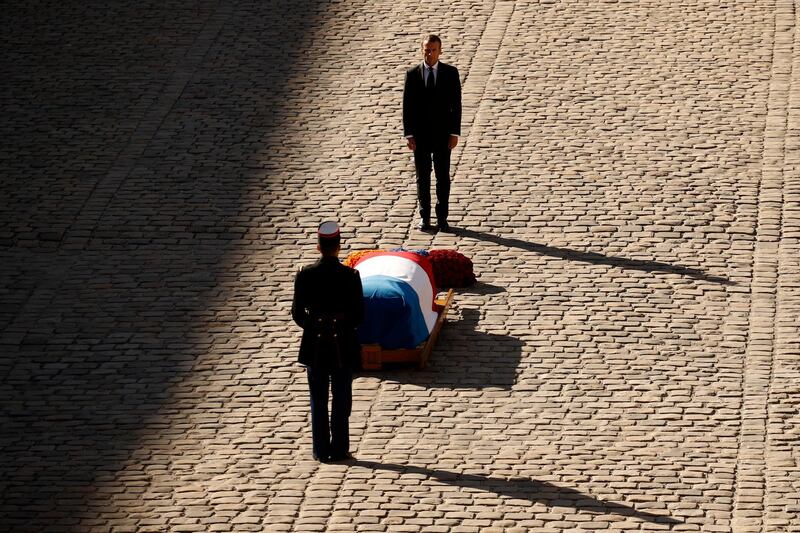 French President Emmanuel Macron stands behind the coffin of Charles Aznavour during a ceremony to pay a tribute to late singer Charles Aznavour in Paris. EPAT
