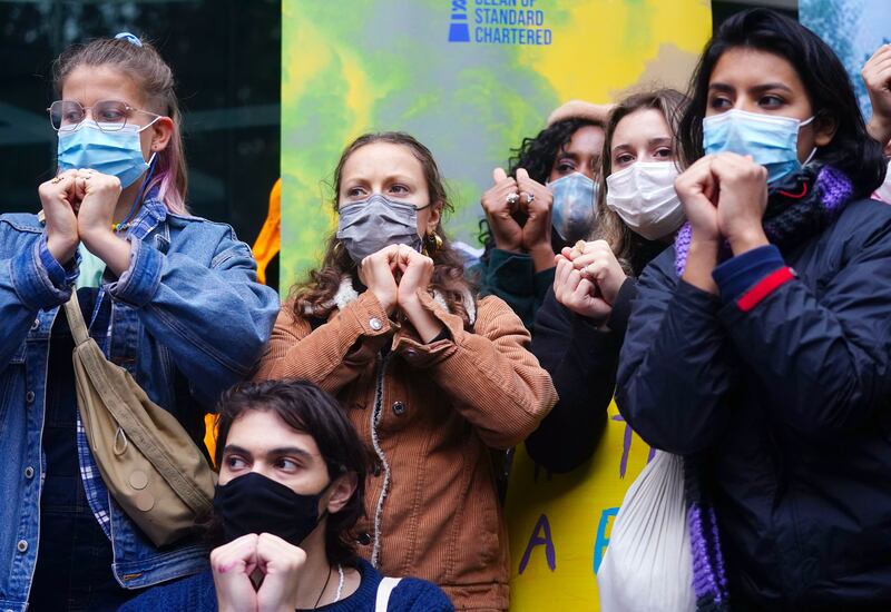 Young climate activists make the sign language symbol for solidarity. PA