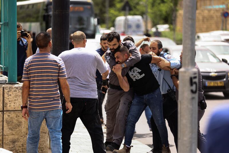 Israeli police detain a protester near Jaffa Gate while the funeral of Abu Akleh, who was killed during an Israeli raid in Jenin in the West Bank, takes place in Jerusalem. Reuters