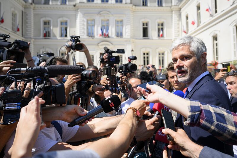 Laurent Wauquiez, right, president of the Regional Council of Auvergne-Rhone-Alpes, speaks to the press following the attack. EPA