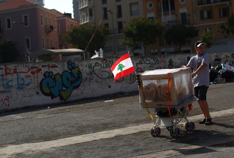 A boy sells bread along a street following Tuesday's blast in Beirut's port area, Lebanon August 8, 2020. REUTERS/Hannah McKay