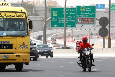 A delivery driver change lanes on Sheikh Zayed Road in Dubai. Victor Besa / The National