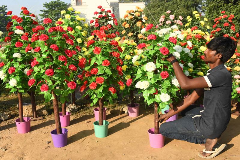 A worker arranges artificial flowers in Amritsar. AFP