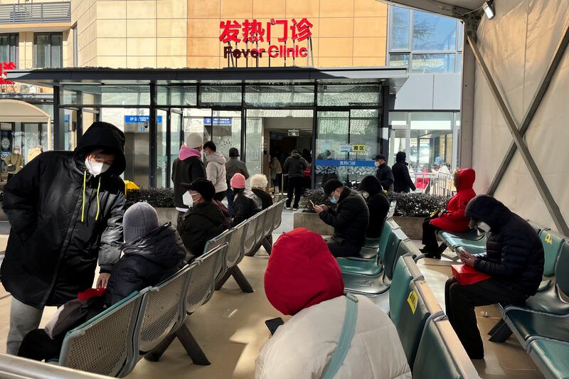 People wait outside a fever clinic at a hospital in Shanghai. Reuters