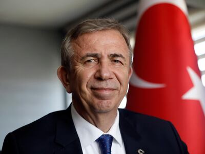 In this Monday, March 25, 2019 photo, Mansur Yavas, the mayoral candidate of Turkey's main opposition alliance for Ankara, talks to The Associated Press in Ankara, Turkey, ahead of local elections scheduled for March 31, 2019. For Turkey's President Recep Tayyip Erdogan, the local elections are not just a vote to decide who should collect the garbage and maintain roads _ they are about Turkey's future national "survival." (AP Photo/Burhan Ozbilici)