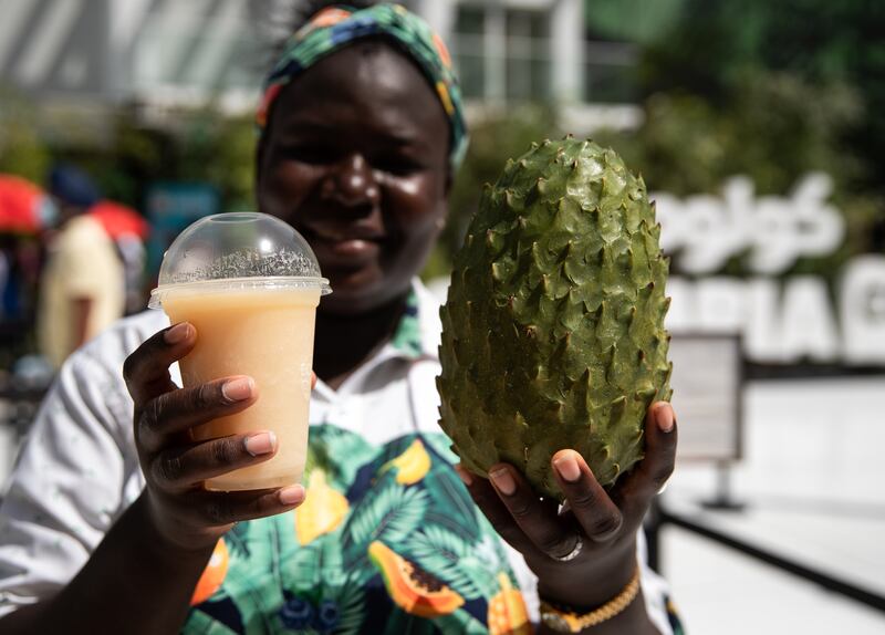 A woman presents the soursop gelato at the Colombia Pavilion.