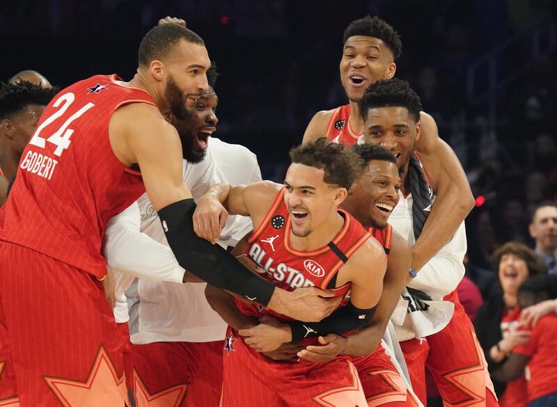 Team Giannis guard Trae Young of the Atlanta Hawks celebrates with teammates after making a shot at the halftime buzzer. Kyle Terada-USA TODAY