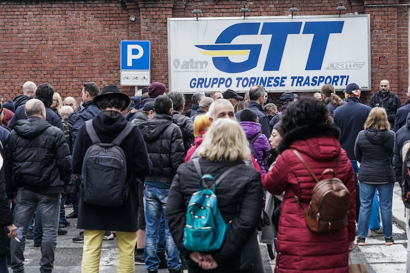 People gather to protest against the green pass vaccine passport at the Turin public transport centre, in Italy. A green pass is required to enter all Italian workplaces. EPA