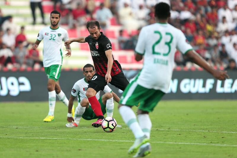 Al Ahli’s Everton Ribeiro, centre, makes his way through traffic against Emirates during their Arabian Gulf League match in Dubai on Saturday. Christopher Pike / The National