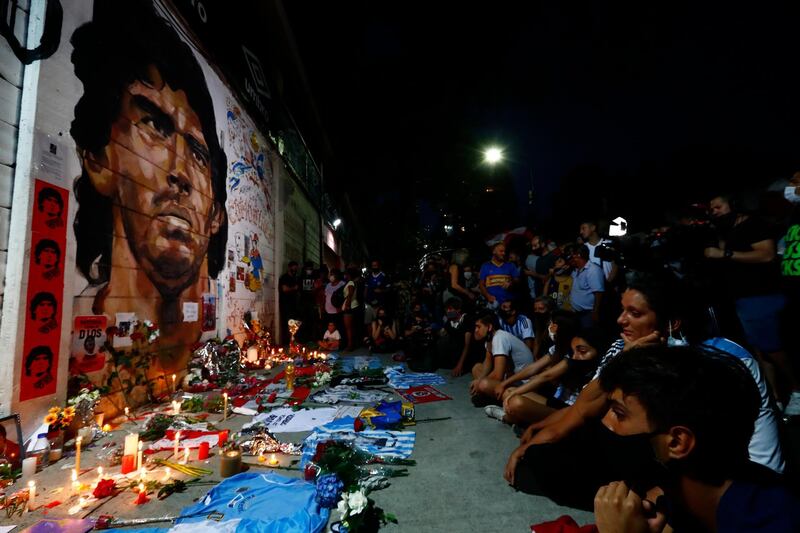 Fans hold a vigil for Maradona outside the stadium of Argentinos Juniors, where he started as a professional footballer, in Buenos Aires. AP