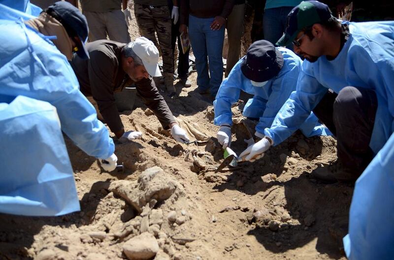 Members of the Iraqi forensic team exhume the bodies of soldiers killed by ISIS from a mass grave in the compound of the former president Saddam Hussein in Tikrit on April 6, 2015. Reuters