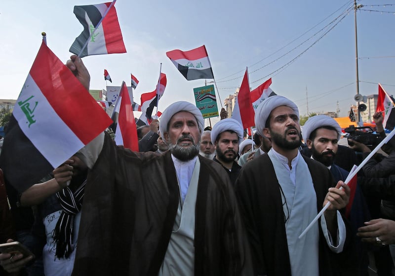 Iraqi Shiite Muslim clerics and supporters of the Hashed Al Shaabi armed network, demonstrate in the capital Baghdad's Tahrir Square. Several thousand Iraqis backing the paramilitary force close to Iran flooded the Iraqi capital's main protest camp today, worrying anti-government demonstrators who have denounced Tehran's role in their country.  AFP