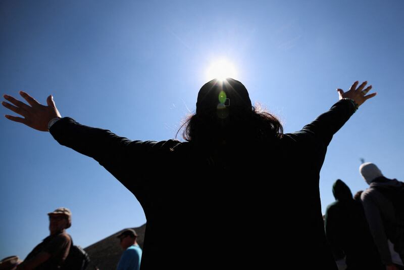 A woman raises her arms to welcome the spring equinox in Teotihuacan in Mexico City. Reuters