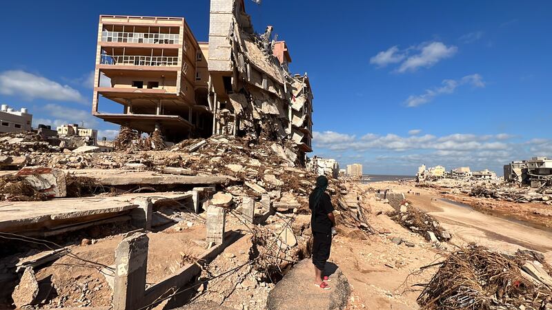 A man stands near collapsed buildings at the port city of Derna, eastern Libya. EPA