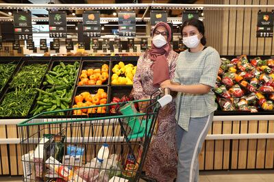 Hasnaa Nofal and her daughter Janna Osama stock up for Ramadan. Pawan Singh / The National 