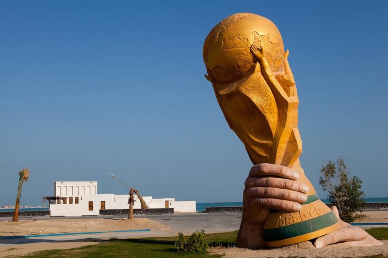 A huge sculpture of the Fifa World Cup trophy is pictured by the sea front in Doha, Qatar. The FIFA World Cup 2022 will take place in Qatar. Nadine Rupp / Getty Images
