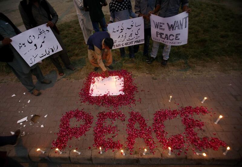 The word 'Peace' drawn with rose petals during a candlelight vigil for the victims of an attack on the Quetta Police Training Academy, in Islamabad, Pakistan, on October 25, 2016. Anjum Naveed/AP Photo