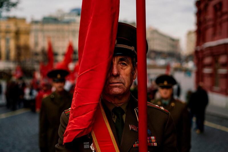 Russian Communist party activists and supporters march towards Lenin's Mausoleum to lay flowers during a ceremony dedicated to the upcoming 102nd anniversary of the Bolshevik Revolution also known as the October Revolution in which Vladimir Lenin’s Bolshevik Communist government came to power - on Red Square in downtown Moscow. AFP