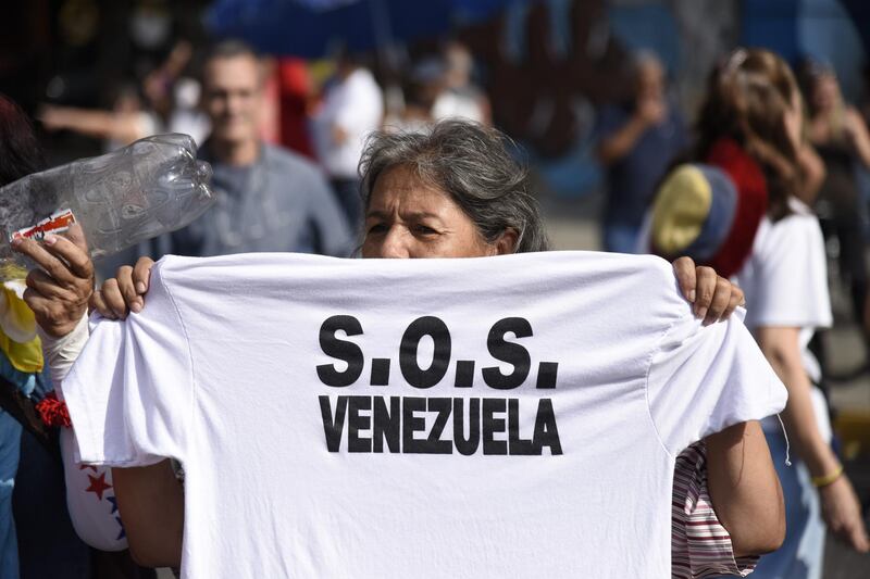 A participant holds a T-shirt during a protest against Venezuelan President Nicolas Maduro in Caracas, Venezuela, on Tuesday, March 12, 2019. Caracas began going dry Monday as the country’s power crisis put utilities out of commission, risking supplies for 5.5 million people. Photographer: Carlos Becerra/Bloomberg