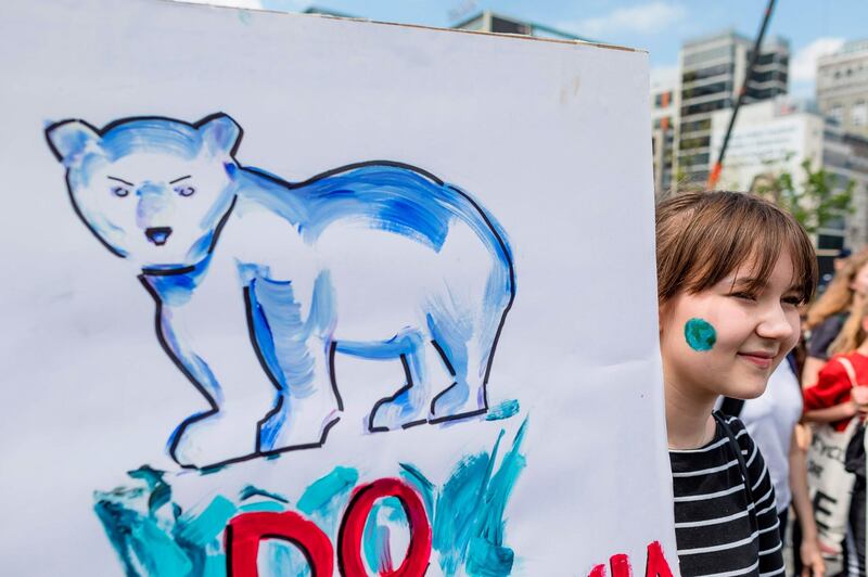 A young protester holds up a placard showing a polar bear during the demonstration in Warsaw. AFP