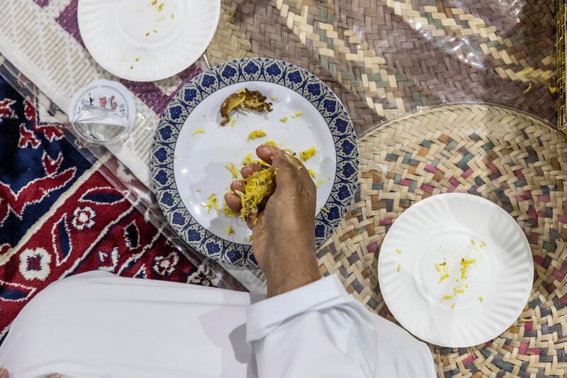 Eating with your right hand and balling up rice in the traditional way.