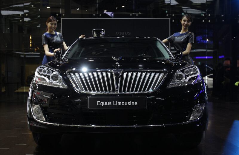 GOYANG, SOUTH KOREA - MARCH 28:  Models pose next to a Hyundai Equus Limousine at the Seoul Motor Show 2013 on March 28, 2013 in Goyang, South Korea. The Seoul Motor Show 2013 will be held in March 29-April 7, featuring state-of-the-art technologies and concept cars from global automakers. The show is its ninth since the first one was held in 1995. About 384 companies from 14 countries, including auto parts manufacturers and tire makers, will set up booths to showcase trends in their respective industries, and to promote their latest products during the show.  (Photo by Chung Sung-Jun/Getty Images) *** Local Caption ***  164770502.jpg