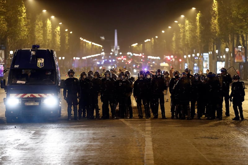 Riot police stand on the Champs-Elysees. EPA