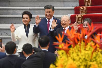 Chinese President Xi Jinping and Vietnam's Communist Party General Secretary, Nguyen Phu Trong, attending a ceremony in Hanoi with their wives in December. AFP