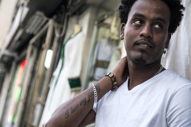 Eritrean asylum seeker Isake Malke,27,in south Tel Aviv where he lives  had the words I love my family tattooed on his arm, added: "I am thinking about jail all the time. How I will spend my life there."(Photo by Heidi Levine for The National).