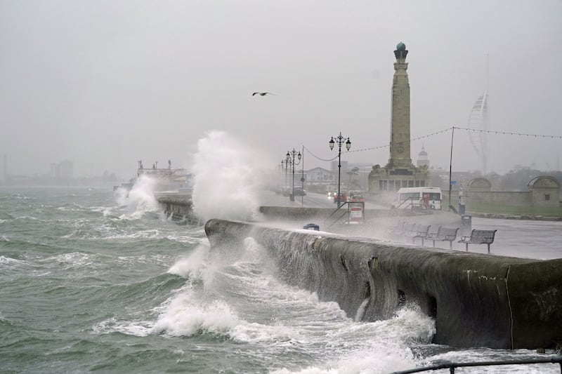 Waves crash against the seafront in Southsea. PA