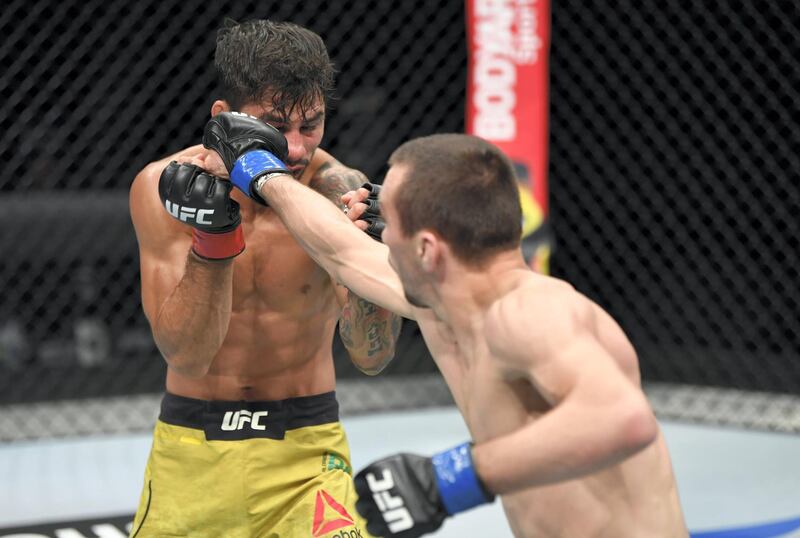 ABU DHABI, UNITED ARAB EMIRATES - JULY 19: (R-L) Askar Askarov of Russia punches Alexandre Pantoja of Brazil in their flyweight bout during the UFC Fight Night event inside Flash Forum on UFC Fight Island on July 19, 2020 in Yas Island, Abu Dhabi, United Arab Emirates. (Photo by Jeff Bottari/Zuffa LLC via Getty Images)