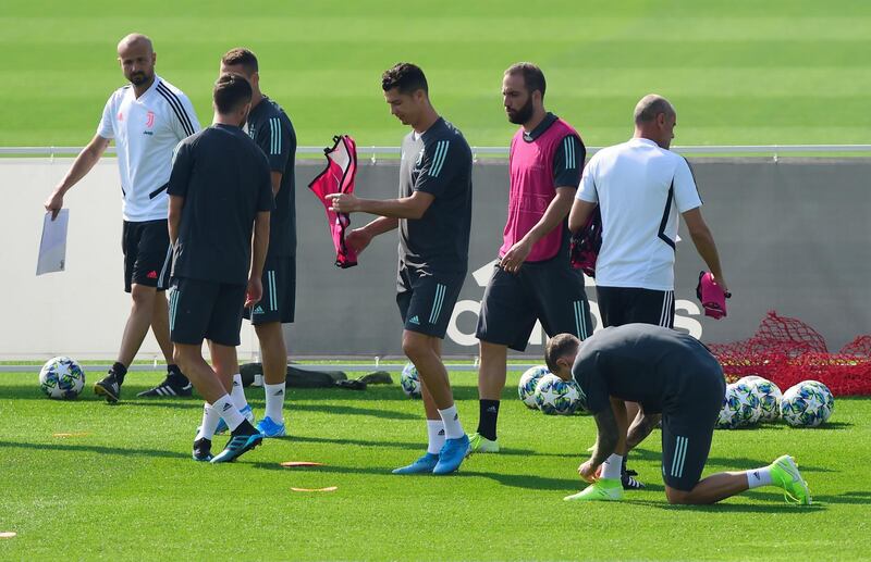 Juventus' Cristiano Ronaldo, with bib in hands, with team mates during training, Reuters