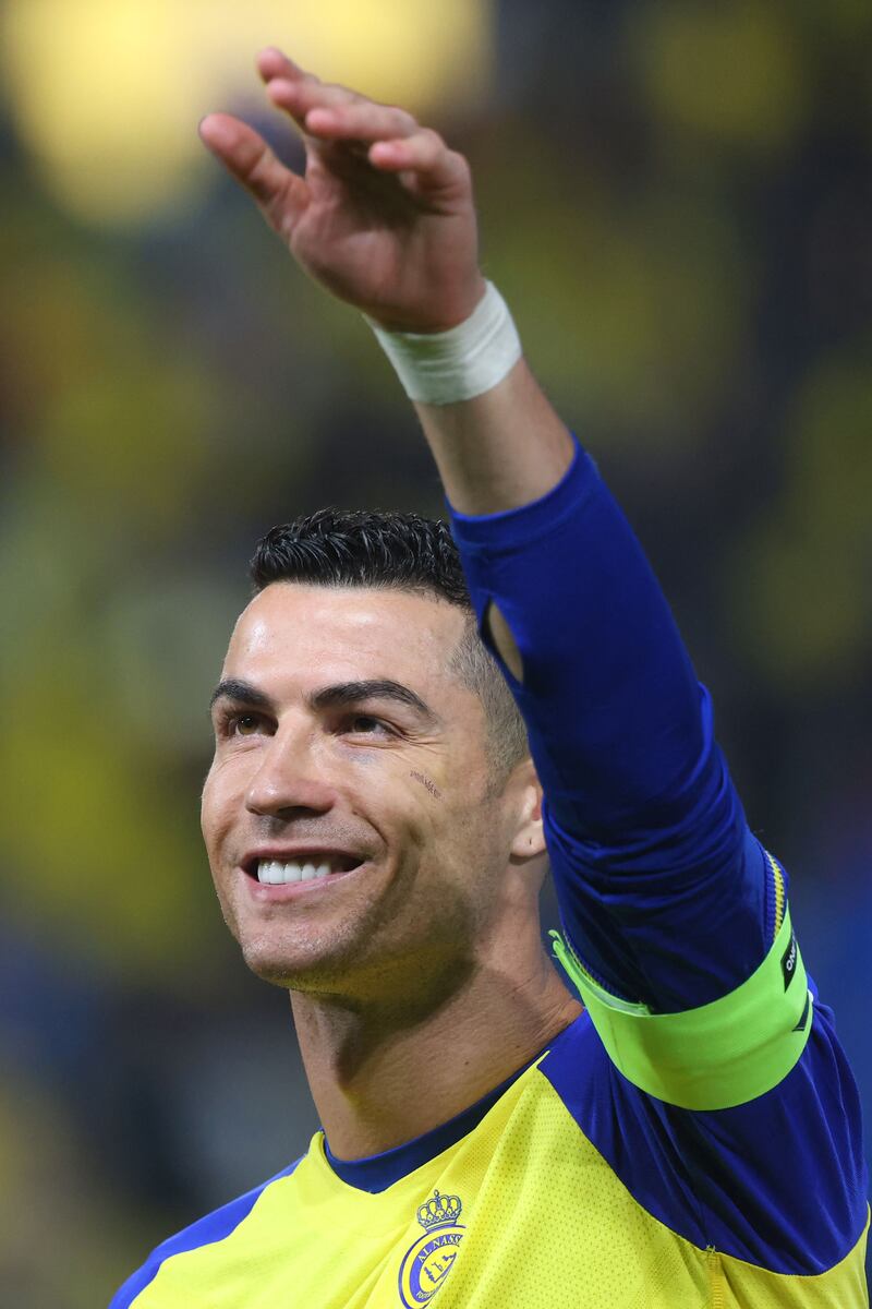 Nassr's Portuguese forward Cristiano Ronaldo greets supporters ahead of the Saudi Pro League football match between Al-Nassr and Al-Ettifaq at the King Fahd Stadium in the Saudi capital Riyadh on January 22, 2023.  (Photo by Fayez NURELDINE  /  AFP)