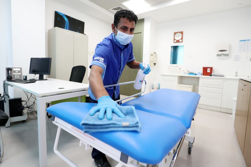 A member of staff cleans a surgery room at the NMC Royal Hospital in DIP, Dubai. Chris Whiteoak / The National