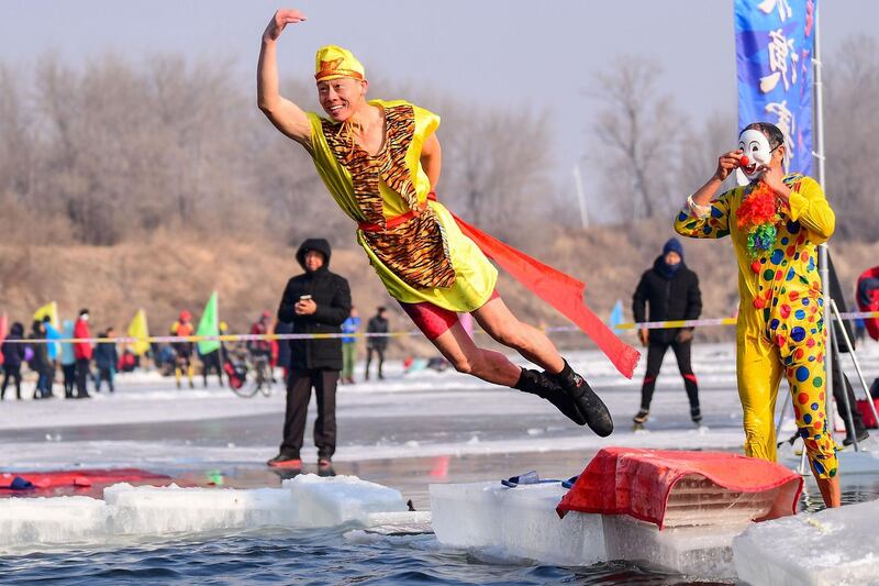 A man wearing a costume diving into a partly frozen lake in Shenyang in China's northeastern Liaoning province, with the temperature of minus 21 degrees Celsius. AFP