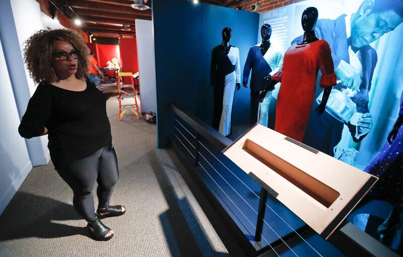 In this photo made on Thursday, Aug. 23, 2018, Ruth E. Carter gives direction as installers work on preparing the costumes from the movie "The Butler" at an exhibit of her cinematic costumes at Pittsburgh's Senator John Heinz History Center in Pittsburgh. The exhibit that opens Saturday, Aug. 25, explores Carter's groundbreaking career. "Heroes & Sheroes: The Art and Influence of Ruth E. Carter in Black Cinema" showcases over 40 costumes from nine movies. The costumes include those from "Amistad," "What's Love Got to do With It," "The Butler," "Malcolm X," "Selma," "Do the Right Thing" and of course "Black Panther." It is scheduled to run to Dec. 2, 2018. (AP Photo/Keith Srakocic)