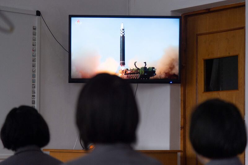 Students at Pyongyang Jang Chol Gu University of Commerce watch footage of the launch of the Hwasong-17 missile. AFP