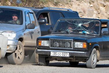 People wait in their cars to be checked as they leave the separatist region of Nagorno-Karabakh to Armenia. AP