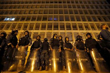 Riot police stand guard during ongoing protests against the Lebanese government, in front of the Central Bank, in Beirut. AP 