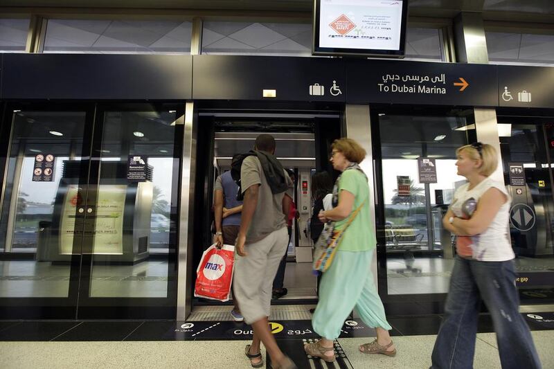 Commuters board the Dubai Tram at Sufouh Station. Jeffrey E Biteng / The National