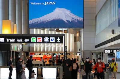 Visitors wearing face masks arrive at Narita international airport near Tokyo in June 2022. AP Photo / Shuji Kajiyama
