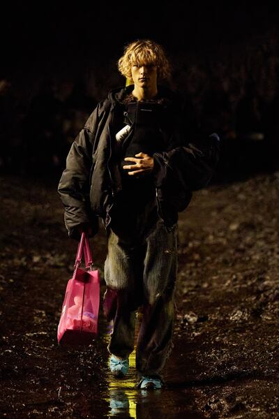 A model carries a baby in a baby sling on the Balenciaga spring summer 2023 runway. Photo: Balenciaga
