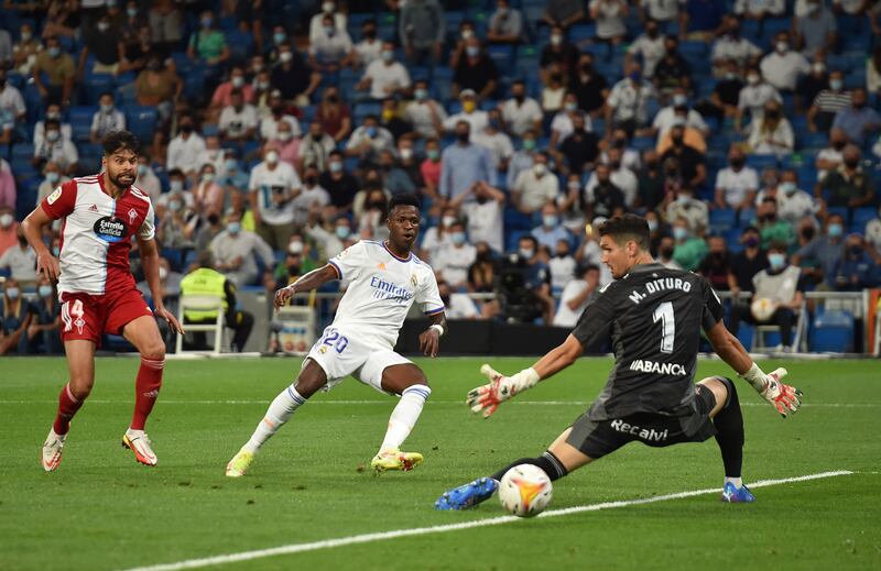 Vinicius Junior of Real Madrid shoots past Matias Dituro of Celta Vigo to score their team's third goal. Getty Images