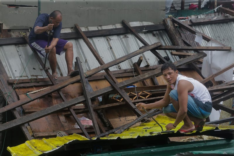 Residents repair their damaged houses after Typhoon Kammuri hit Legazpi City, Albay. Reuters