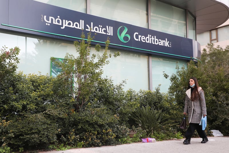 A woman walks past a branch of Creditbank in Beirut. Reuters
