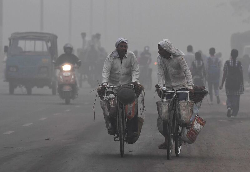 Indian commuters drive amid heavy smog in New Delhi on November 7, 2017.
New Delhi woke up to a choking blanket of smog on November 7 as air quality in the world's most polluted capital city reached hazardous levels. The US embassy website said levels of the fine pollutants known as PM2.5 that are most harmful to health reached 703 -- well over double the threshold of 300 which authorities class as hazardous.

 / AFP PHOTO / PRAKASH SINGH