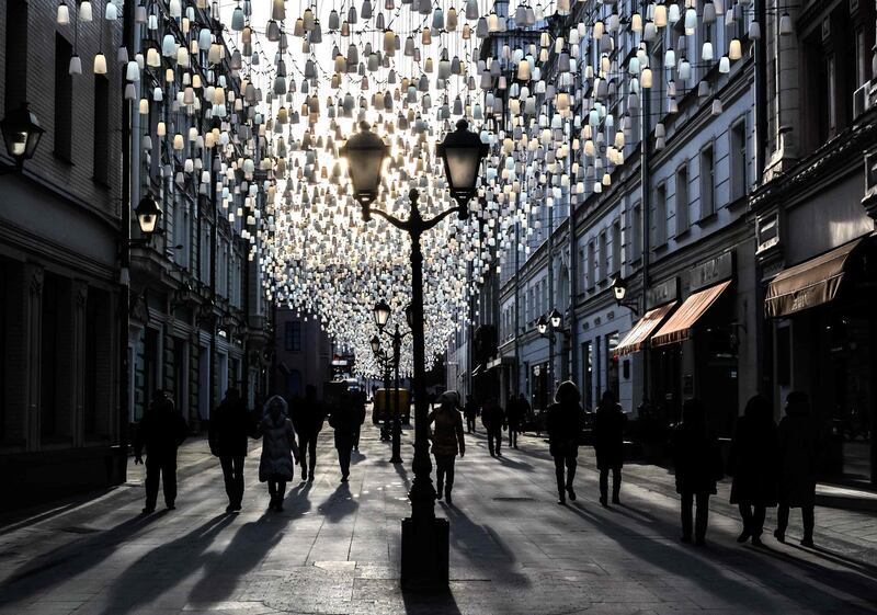 People walk on a street in central Moscow. AFP