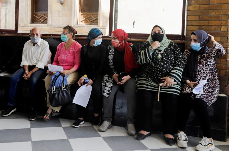 People wait to receive the vaccine in Cairo. Reuters