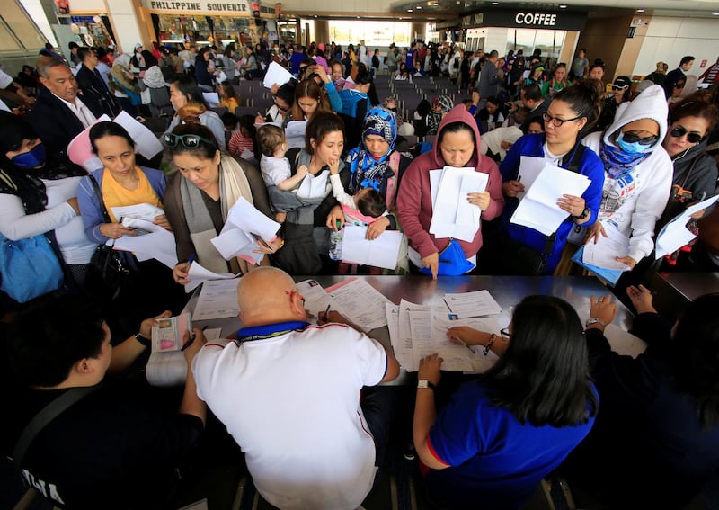 Around 190 Overseas Filipino Workers (OFW) from Kuwait submit their documents upon their arrival at the Ninoy Aquino International Airport, following President Rodrigo Duterte's call to evacuate workers after a Filipina was found dead in a freezer, in Pasay city, Metro Manila, Philippines February 23, 2018, REUTERS/Romeo Ranoco