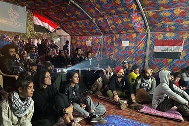 People attend a screening at the Cinema of the Revolution tent in Tahrir Square, Baghdad, Iraq. Photo courtesy of Mohanad Hayal